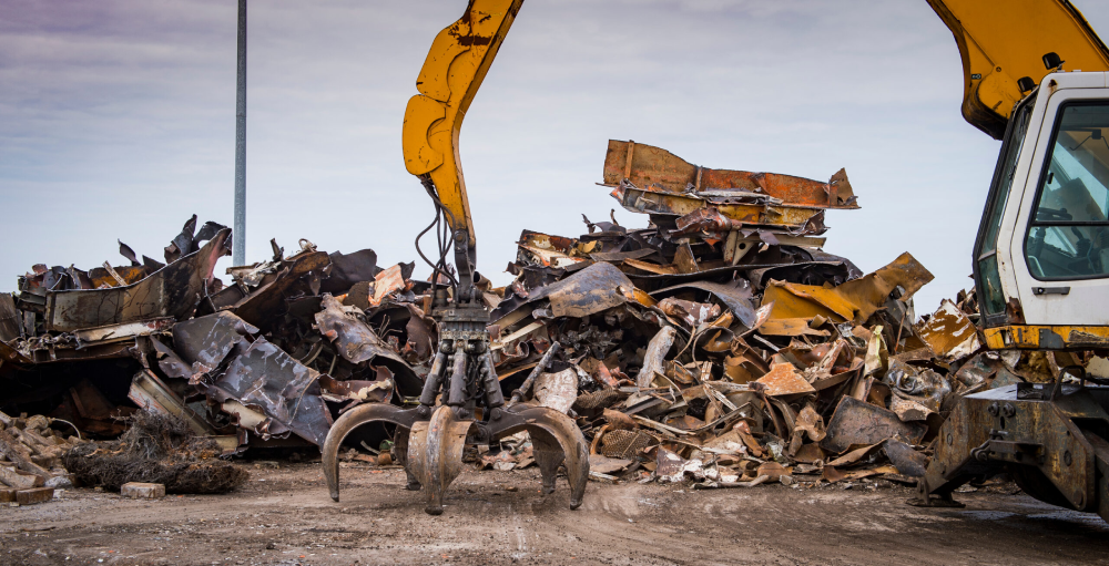 Image of a crane with a large pile of scrap metal