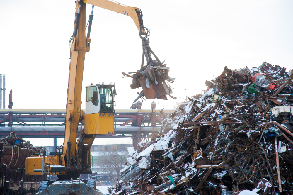 Image of a crane lifting a pile of scrap metal