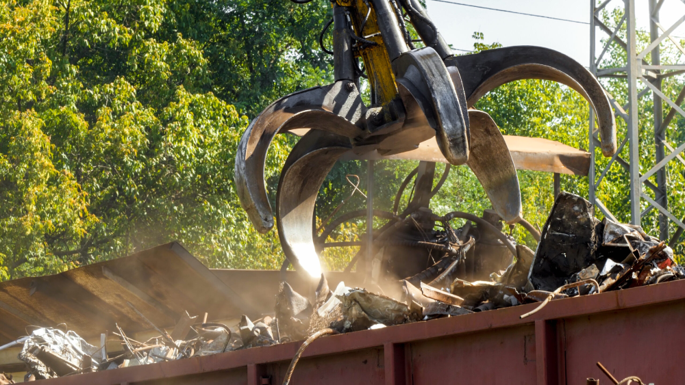 Close up image of a crane picking up rust metals